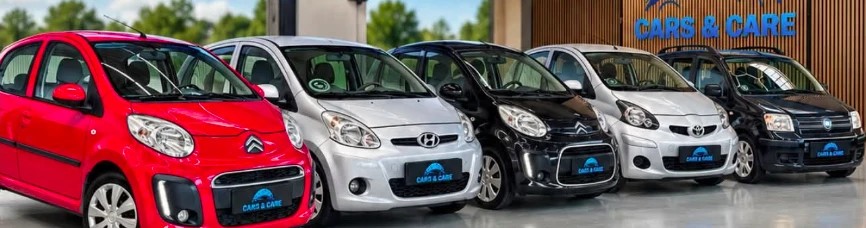 Fem små biler med Cars & Care-nummerplader på række, set forfra, hos Cars & Care i Slagelse